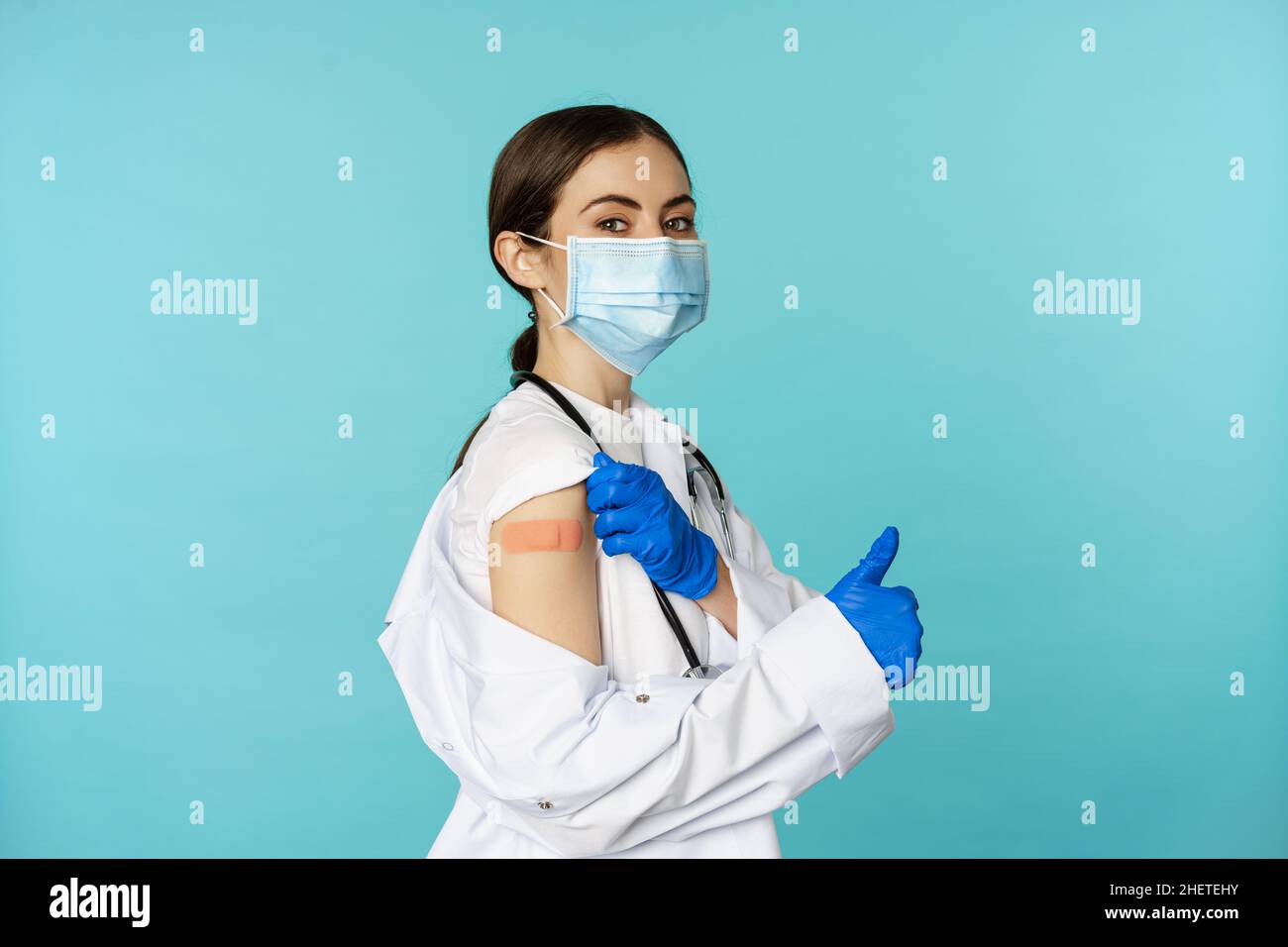 Young female doctor, nurse in medical face mask and hospital uniform ...