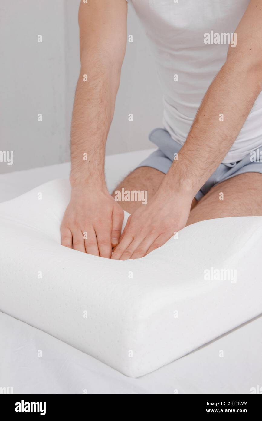 Orthopedic Pillow with a Memory Effect. Medical treatment pillow for sleep. Comfort Memory Pillow under the head with a recess under the shoulder Stock Photo