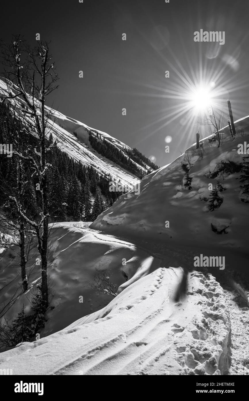 sunny winter day at austrians mountains with ski tracks in snow Stock Photo