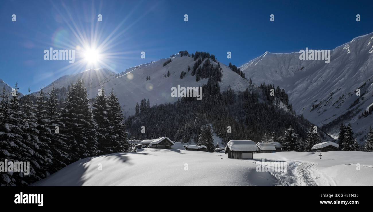 idyllic austrian mountain village at winter with snow and sunny blue sky Stock Photo