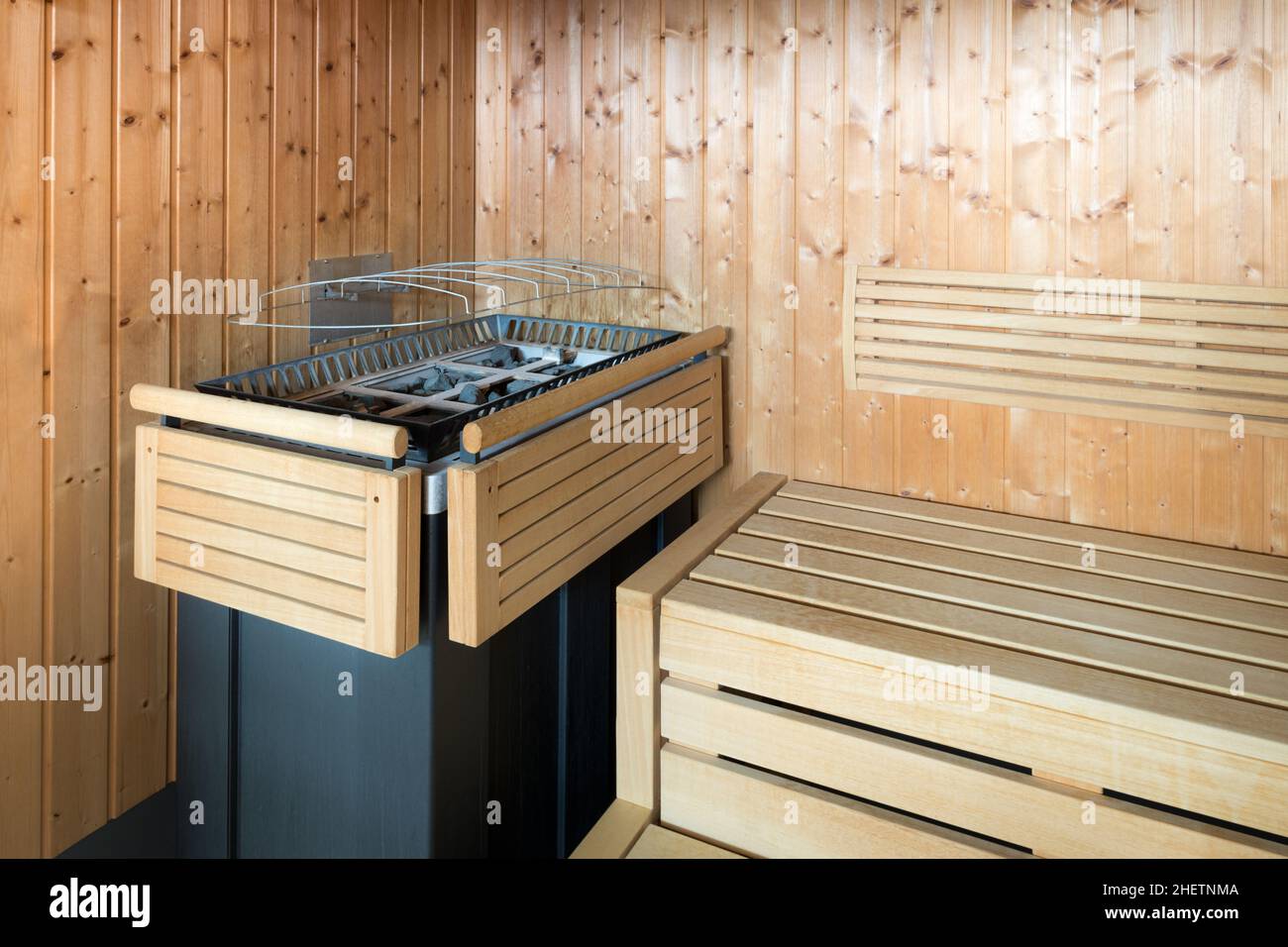 wooden steam sauna with protected stove Stock Photo