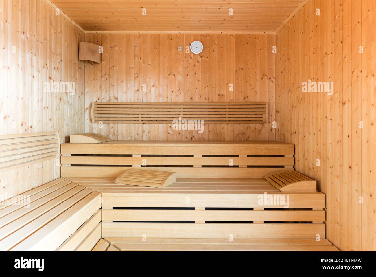 healthy wooden steam sauna with clock and wood loungers Stock Photo