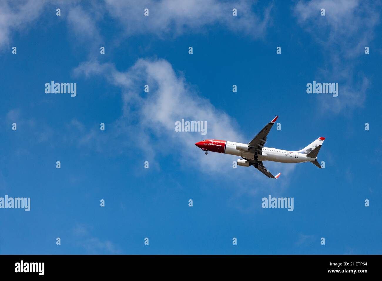 An airplane is seen flying Stock Photo