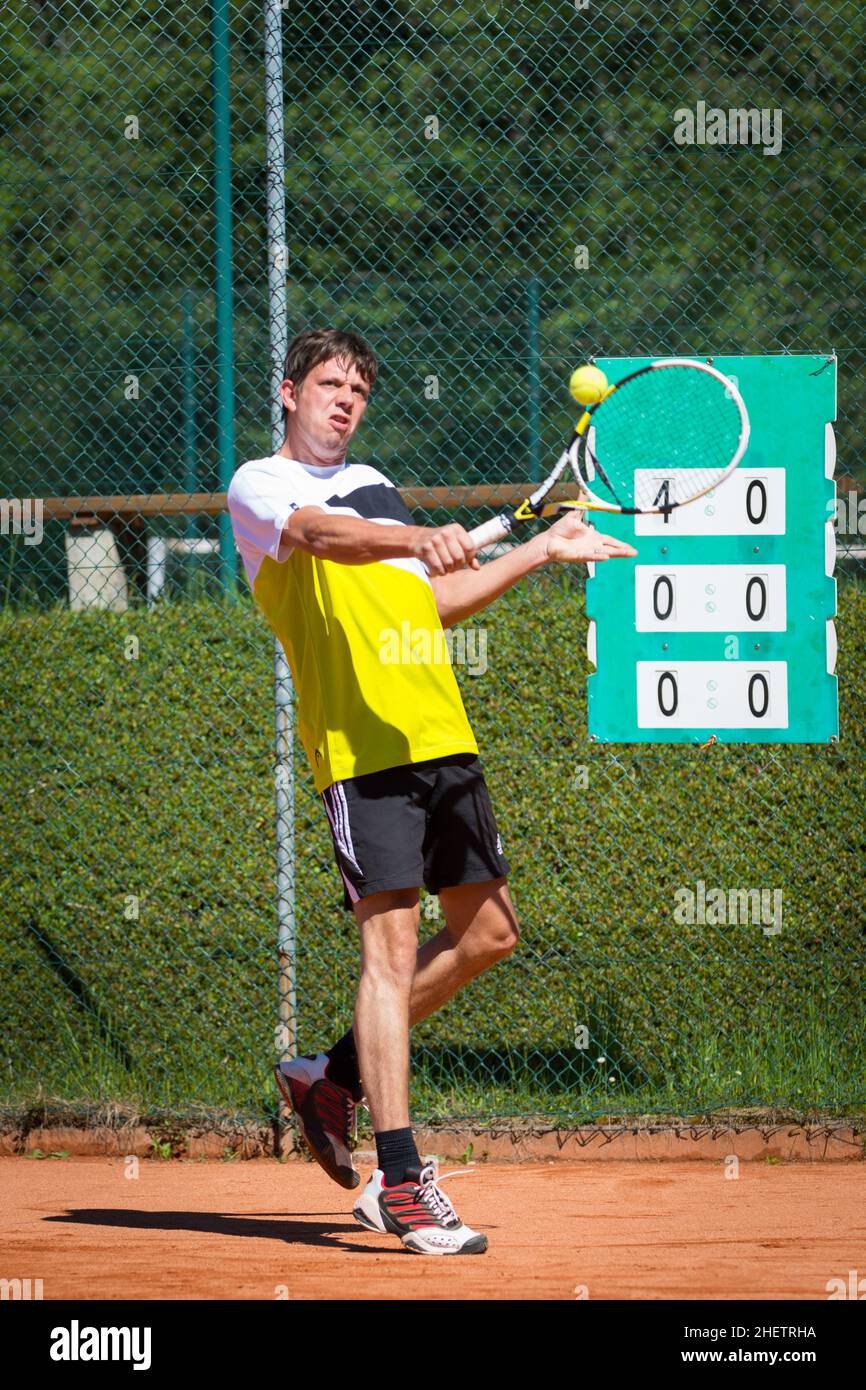 tennis player hits backhand ball with racket Stock Photo Alamy