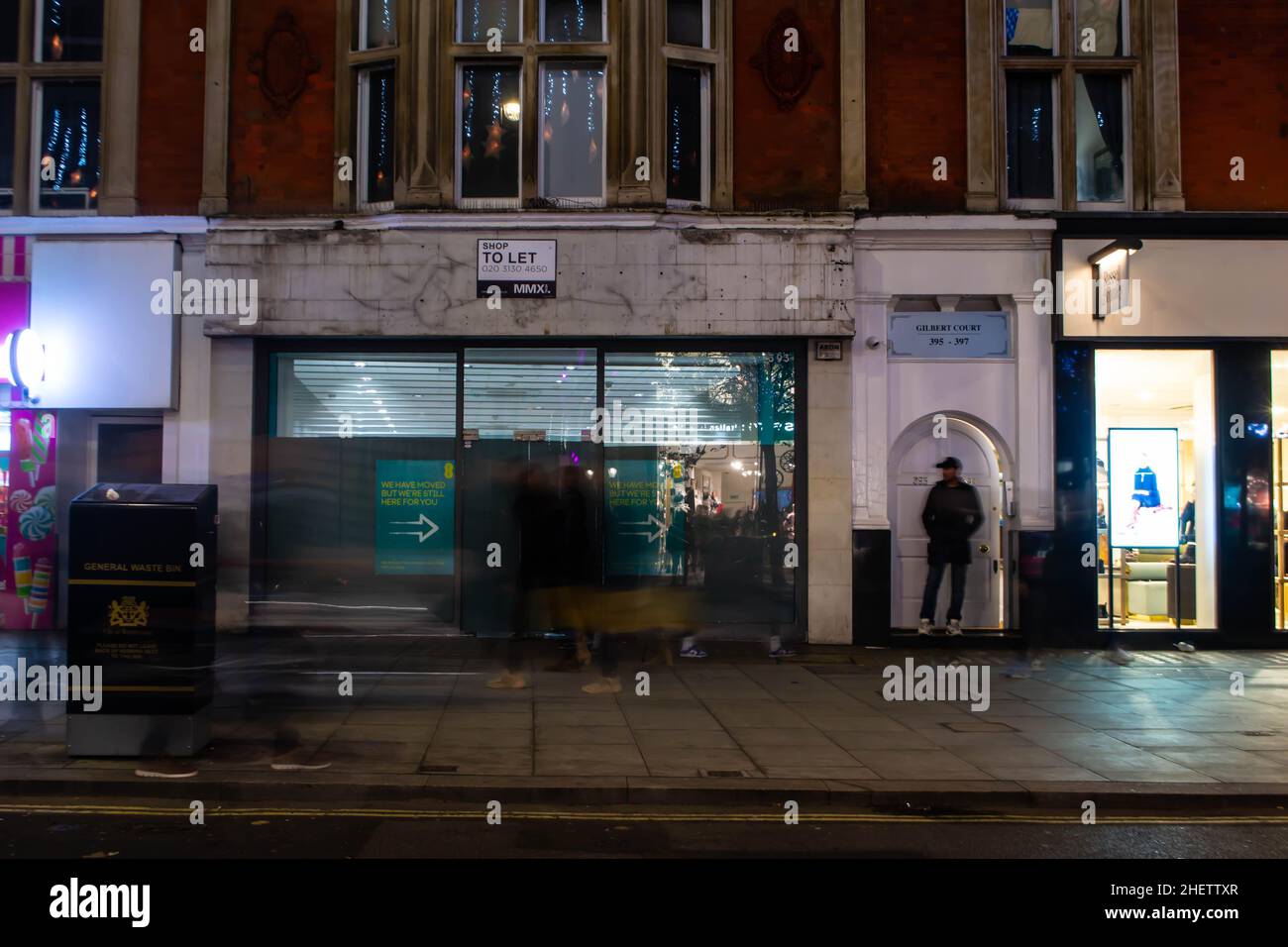 OXFORD STREET, LONDON, ENGLAND- 14 November 2021: Closed shopfront on Oxford Street at night Stock Photo