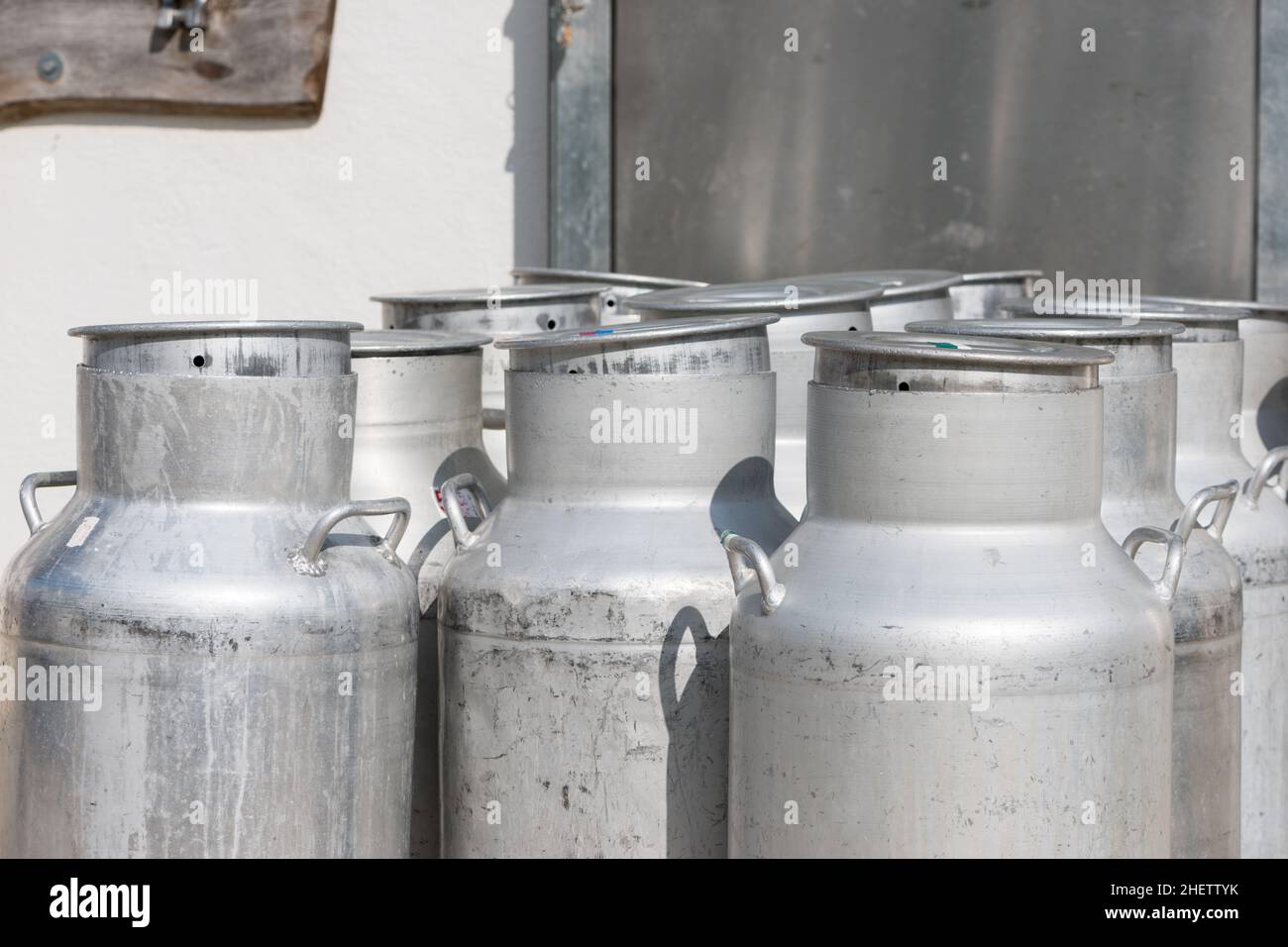 several empty silver cow milk cans with cap Stock Photo