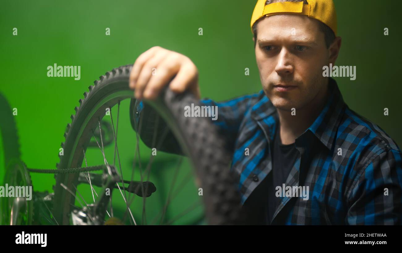 Technician calibrates the wheel of the bicycle. Bicycle repair
