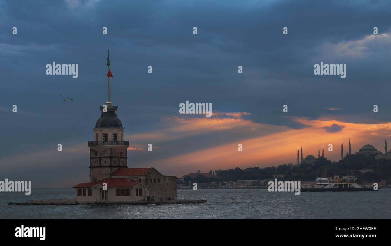 View of the Maiden Tower in Istanbul City of Turkey. Historical Tower and perfect sunset at Bosphorus. Stock Photo