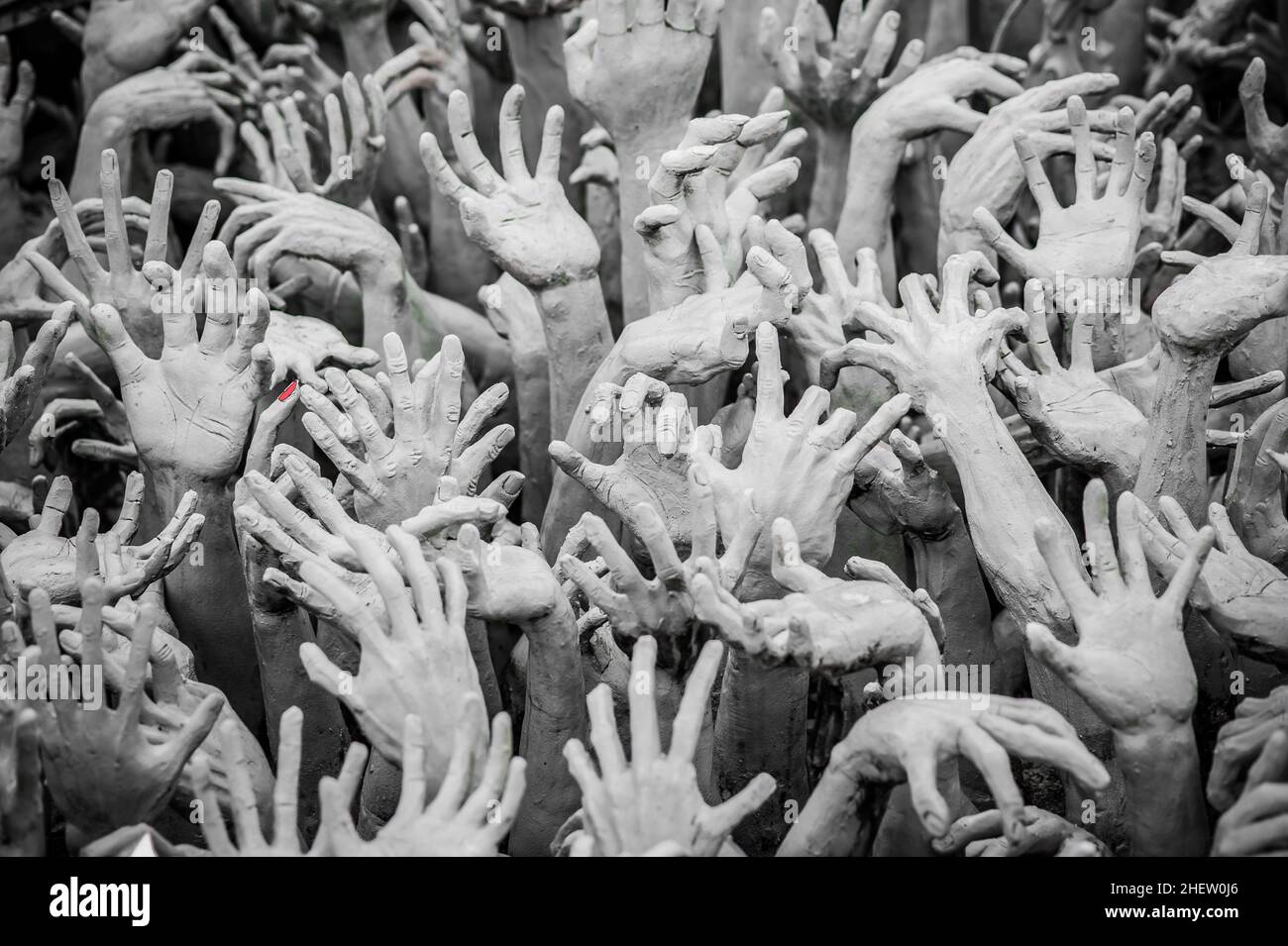 WAT RONG KHUN - WHITE TEMPLE, CHIANG RAI THAILAND - CIRCA MAY 2018. The sculpture of hundreds outreaching hands that symbolize unrestrained desire. Stock Photo