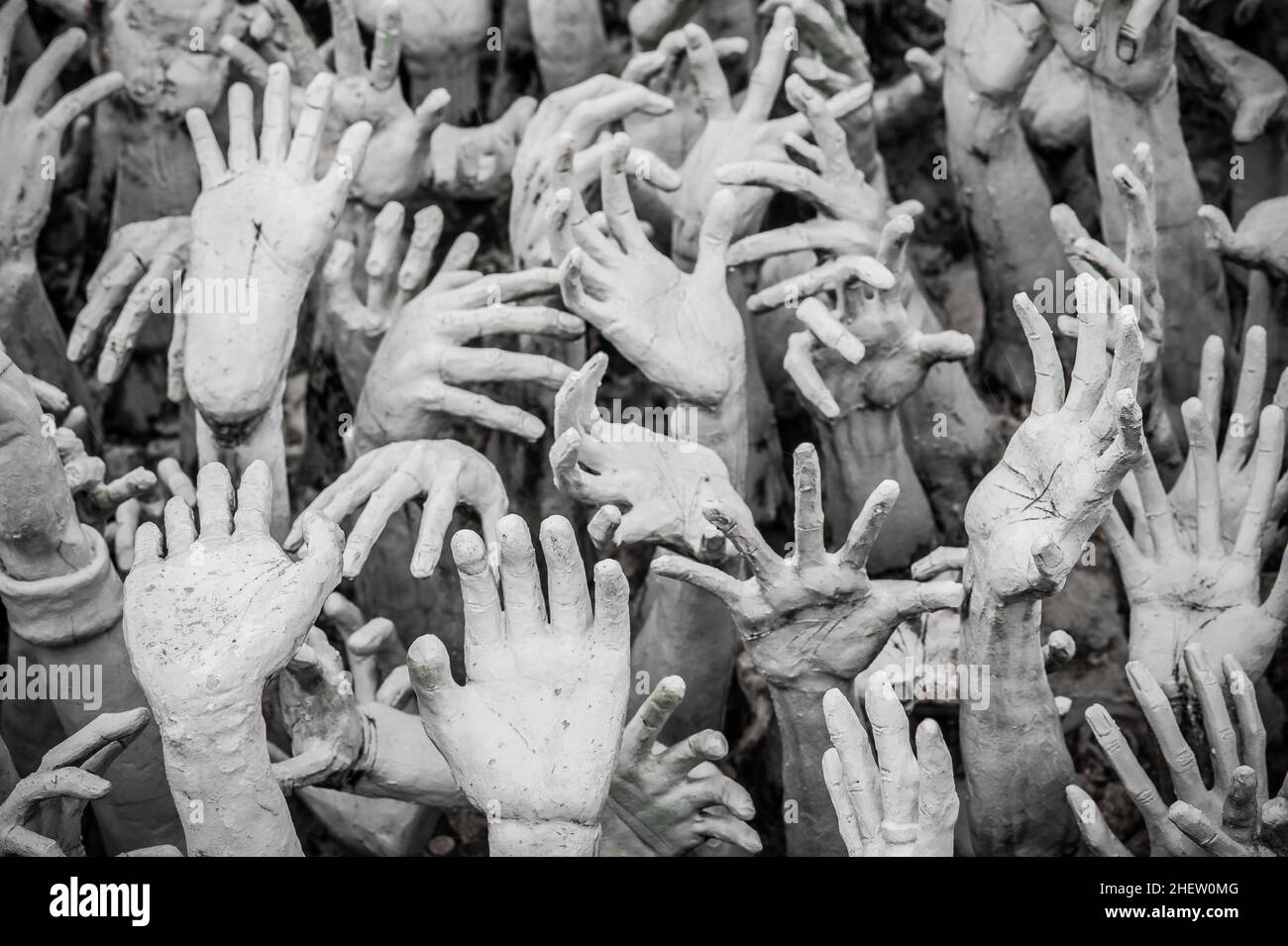 WAT RONG KHUN - WHITE TEMPLE, CHIANG RAI THAILAND - CIRCA MAY 2018. The sculpture of hundreds outreaching hands that symbolize unrestrained desire. Stock Photo
