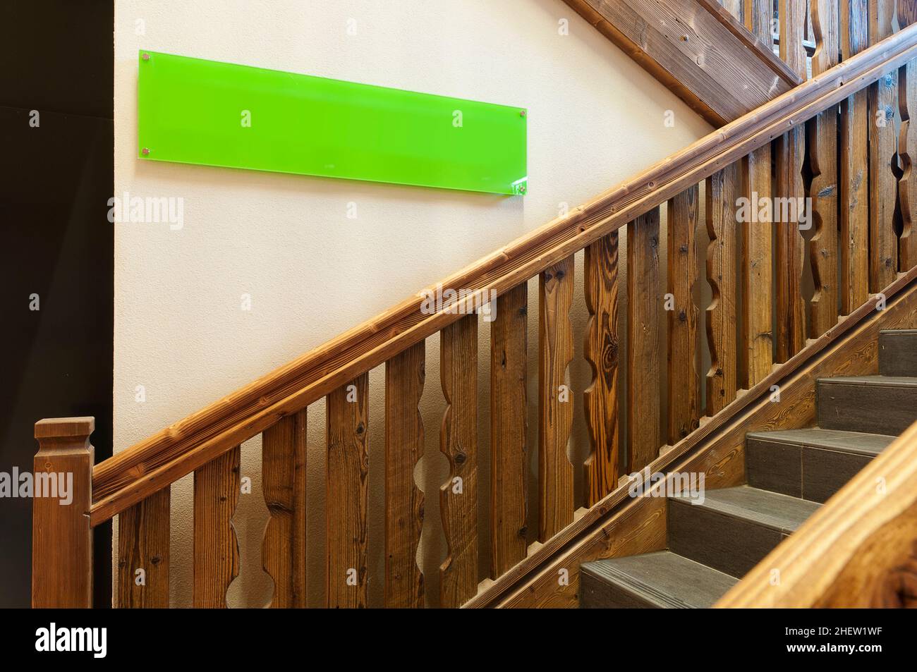 traditional wooden stairs with a big green sign you can label with your needs Stock Photo
