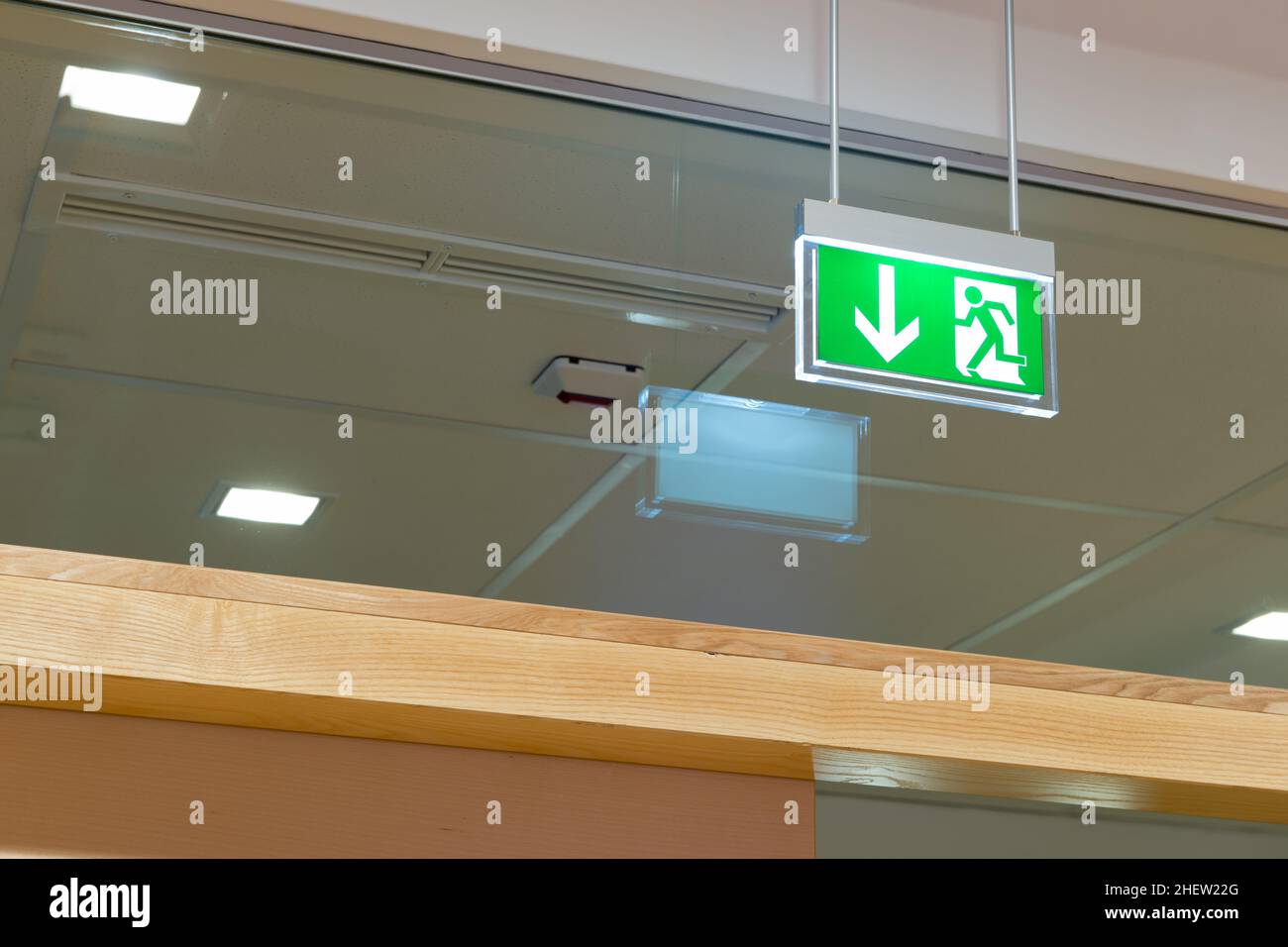 green illuminated exit sign on ceiling Stock Photo Alamy