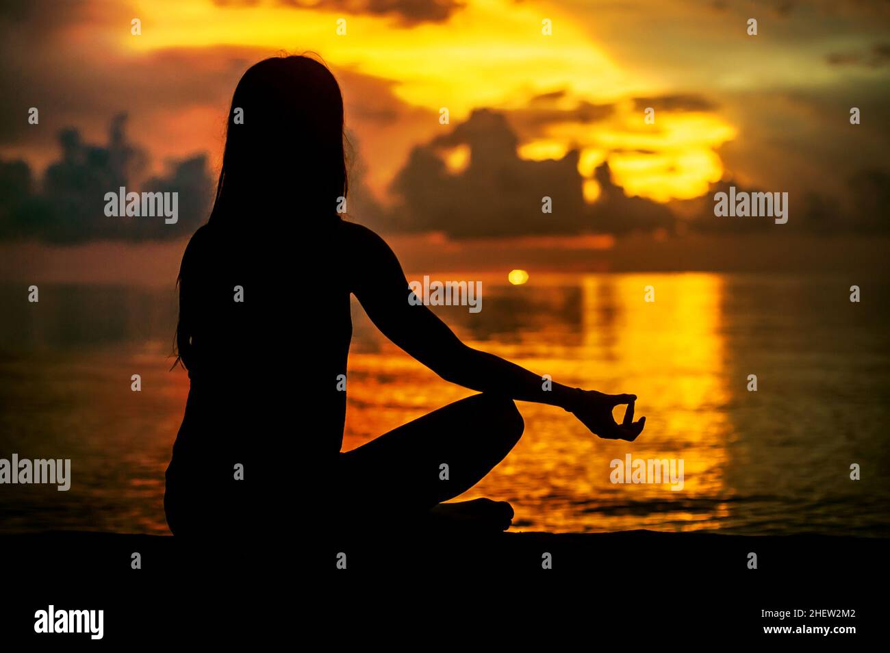 Woman meditating, relaxing in yoga pose at sunset, zen meditation ...