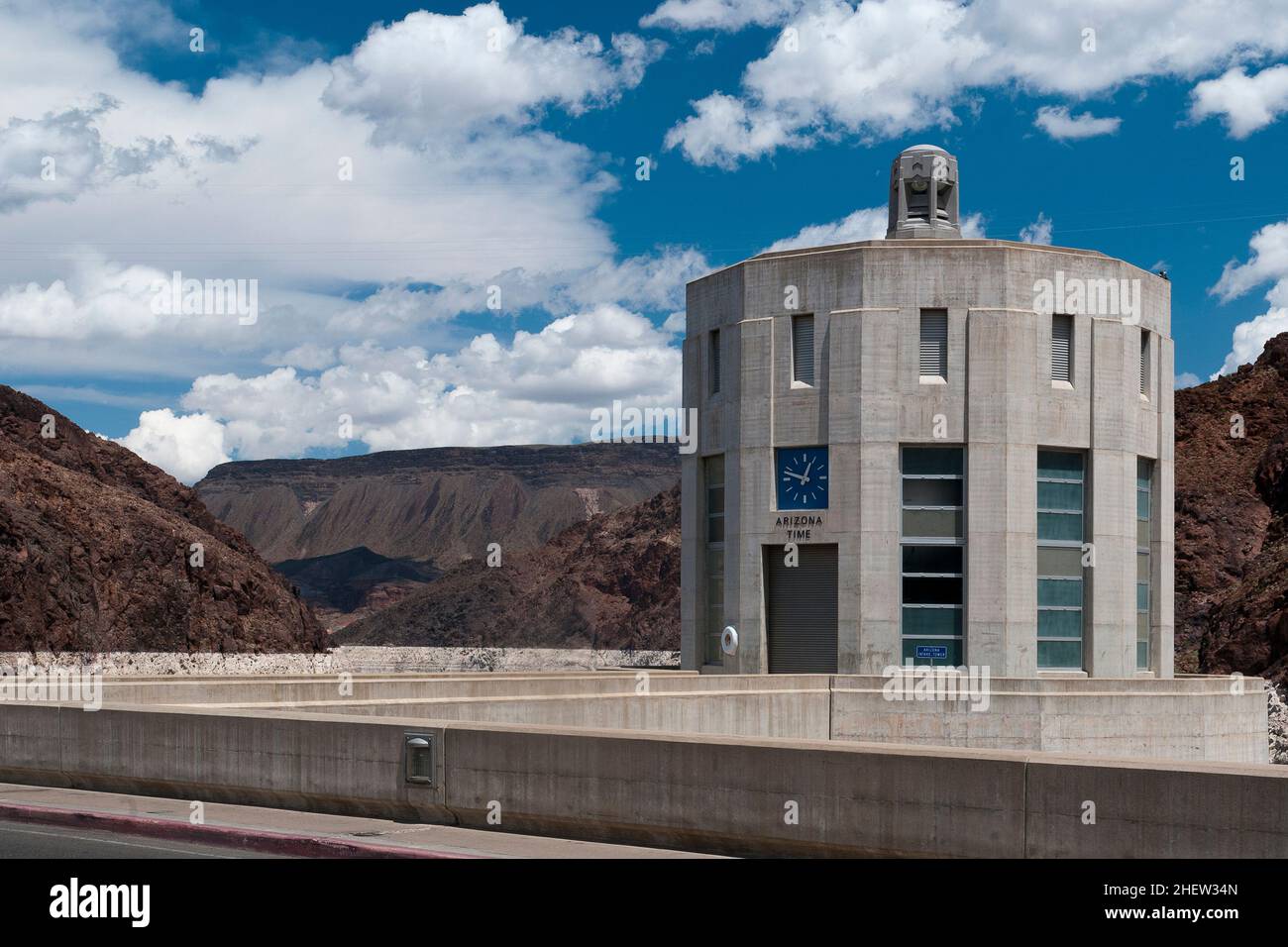 concrete tower with clock at Hoover Dam and cloudy sky Stock Photo