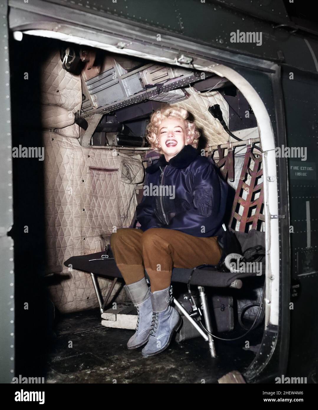 Marilyn Monroe in a helicopter, visiting the troops in Korea, february, 1954. Colorized version. Stock Photo