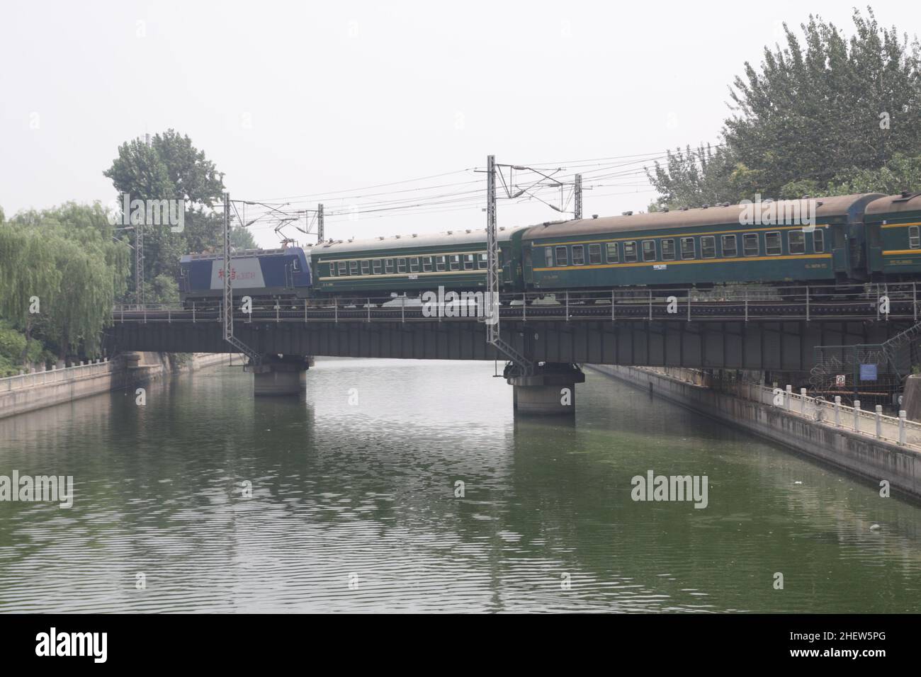 Passenger train on the bridge in Beijing, China. Sleeping cars. Stock Photo