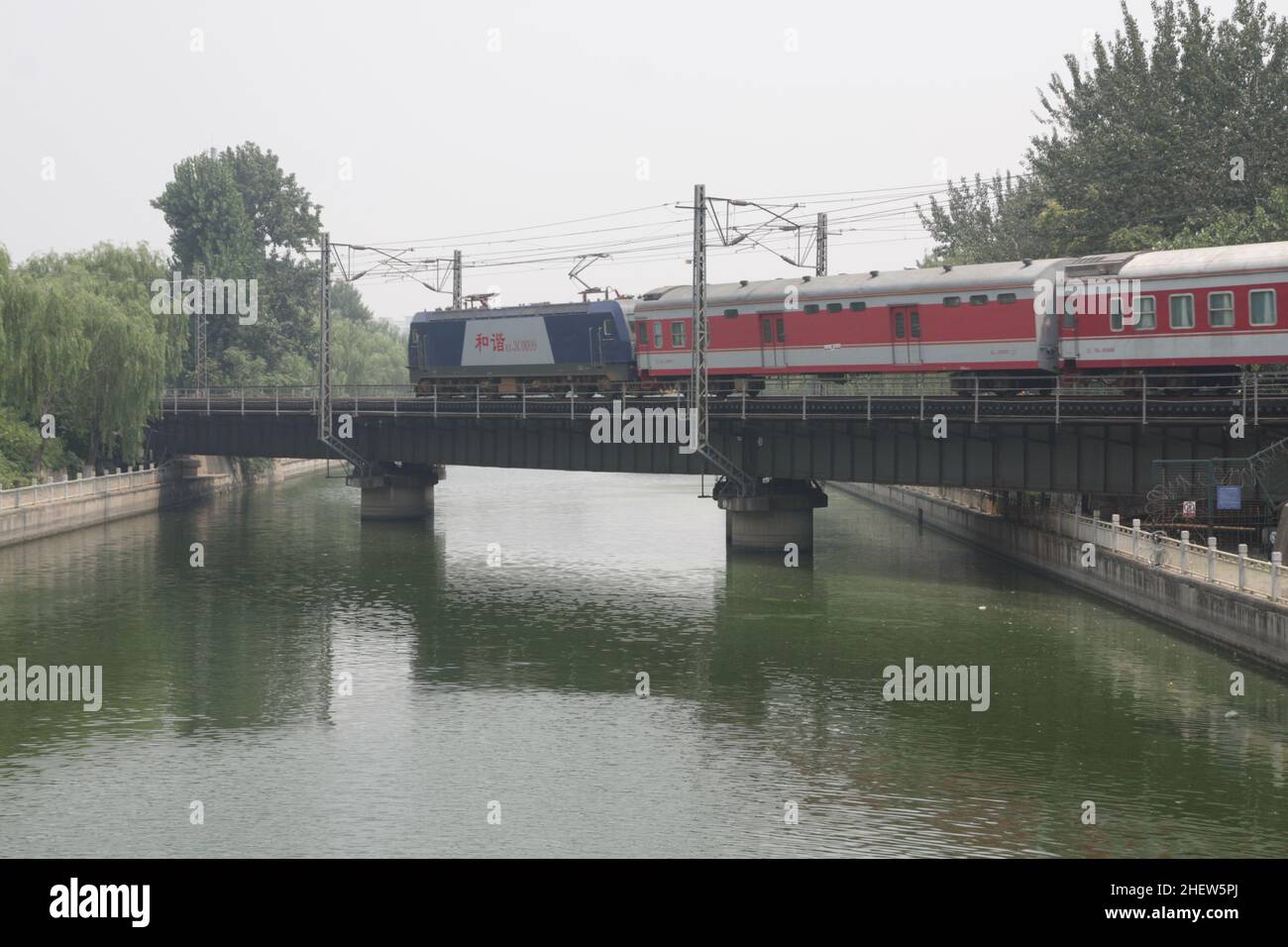 Passenger train on the bridge in Beijing, China. Sleeping cars. Stock Photo