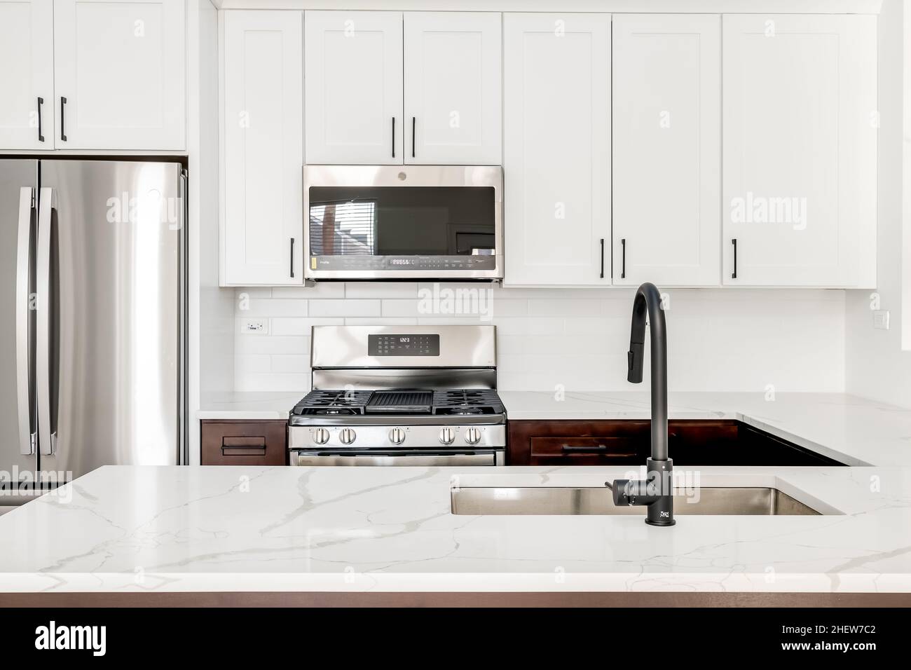 Modern White Kitchen with Black Faucet, Shaker Style Cabinets, and ...
