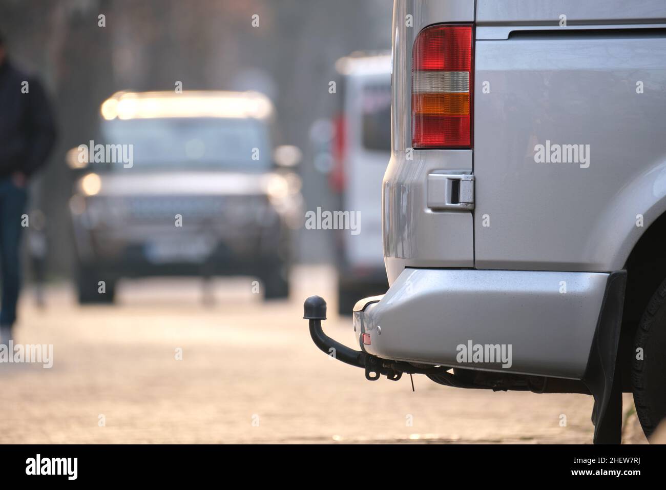 Close up of a van with tow hitch parked on city street side. Stock Photo