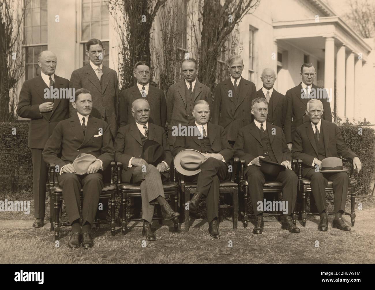 U.S. President Herbert Hoover (seated, center) with his Cabinet (l-r standing) Robert Lamont, Ray Wilbur, Walter Brown, William Mitchell, Arthur Hyde, Charles Adams III, William Doak, (l-r seated) Patrick Hurley, Charles Curtis, Henry Stimson, Andrew Mellon, White House, Washington DC, USA, Harris & Ewing, 1930 Stock Photo