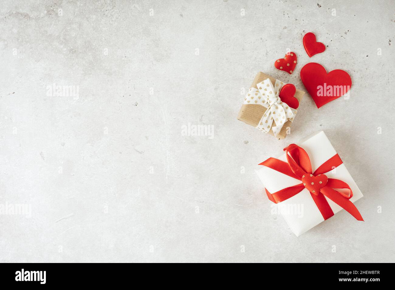 Background with gift and hearts with free space for text on concrete grey background. Valentines day concept. Mother's Day concept. Greetings card Stock Photo