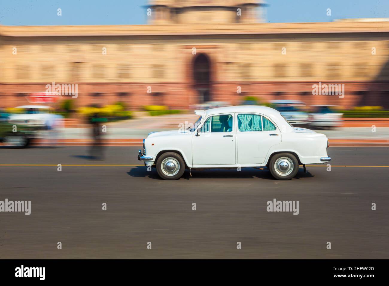 Official Hindustan Ambassador car driving outside North Block, Secretariat Building in New Delhi, India Stock Photo