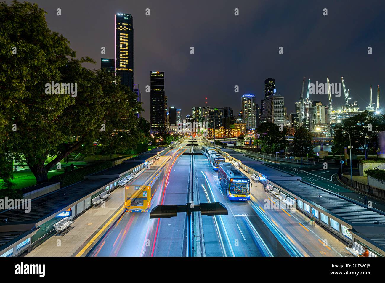 South East Busway at night with Brisbane CBD skyline in background. Brisbane Queensland Stock Photo