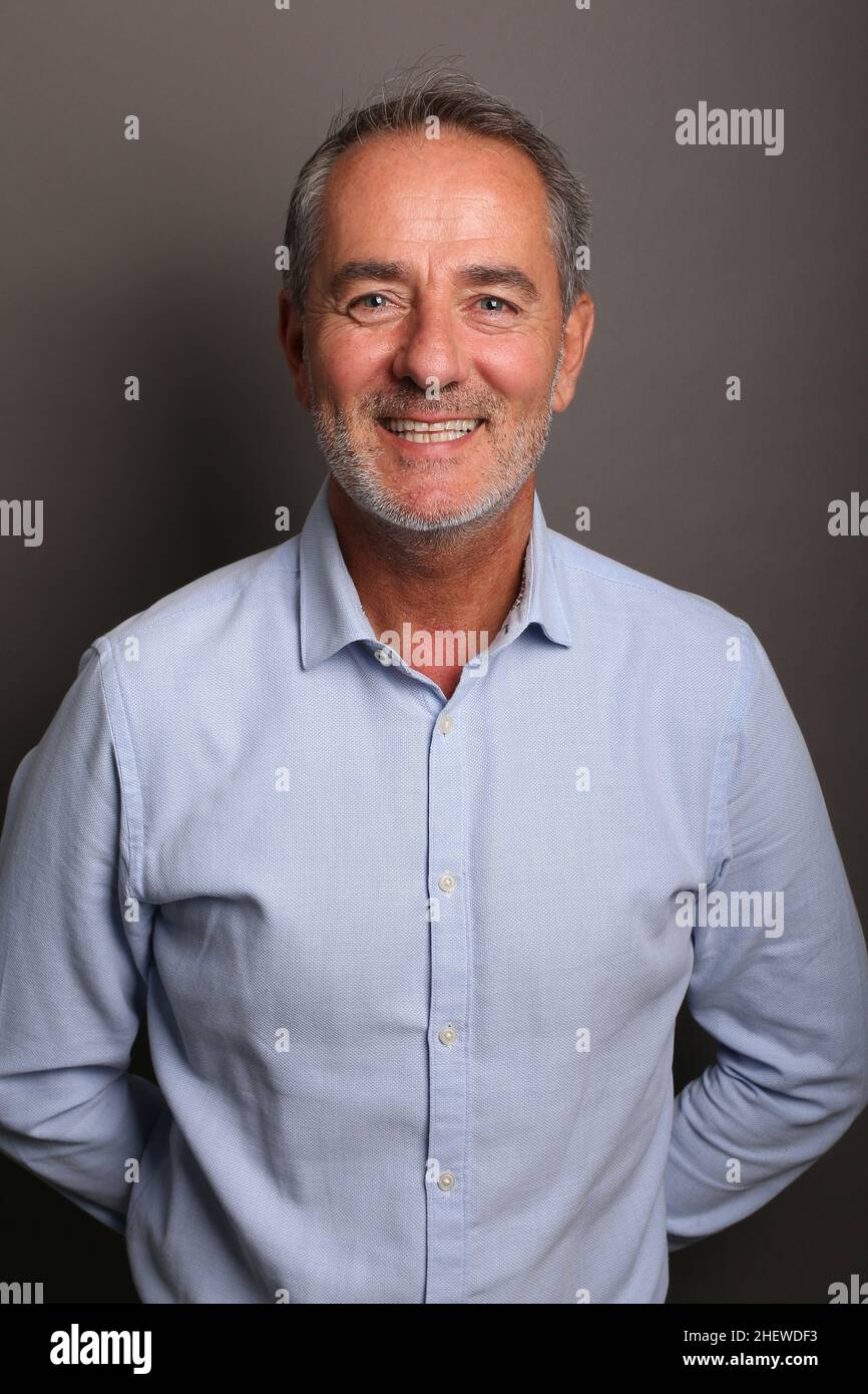 Portrait of a beautiful happy man in front of a colored background Stock Photo