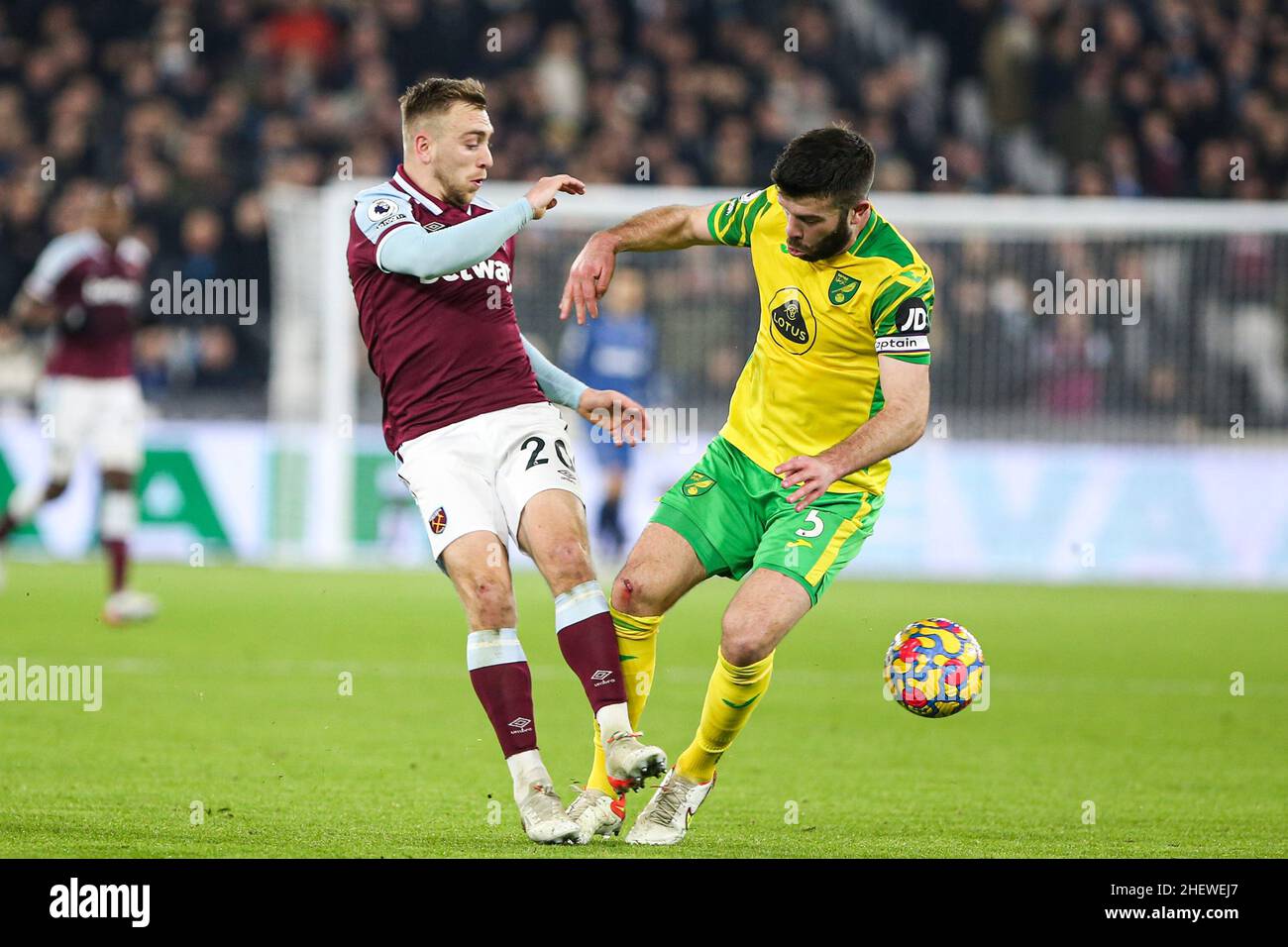 LONDON, UK. JAN 12TH Jarrod Bowen of West Ham United competes with Grant Hanley of Norwich City for the ball during the Premier League match between West Ham United and Norwich City at the London Stadium, Stratford on Wednesday 12th January 2022. (Credit: Tom West | MI News) Credit: MI News & Sport /Alamy Live News Stock Photo