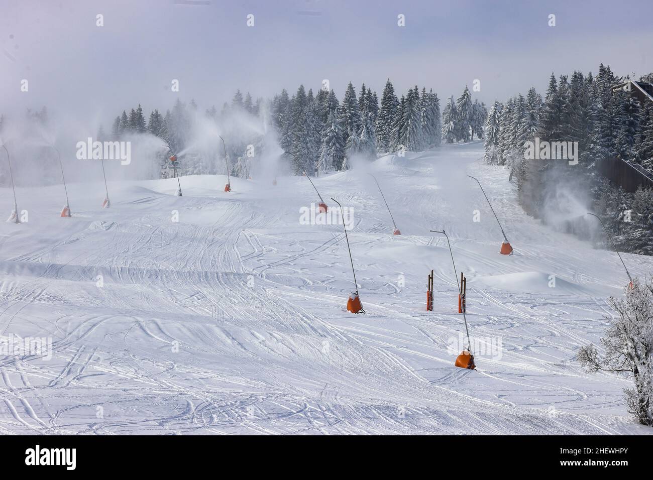 12 January 2022, Saxony, Oberwiesenthal: From numerous lances the slope at the long drag lift is covered with snow. On Saturday (15.01.), this year's ski season will be officially ushered in at Fichtelberg. Due to Corona, the ski area is only open to vaccinated and recovered skiers (2G); a mask must be worn when queuing at the lift and in the lift itself. The 2G status will be checked before purchasing the ski pass as well as in the ski area. For this purpose, a control point and a central sales point for lift tickets will be set up in the parking lot of the Fichtelberg cable car. Photo: Jan W Stock Photo