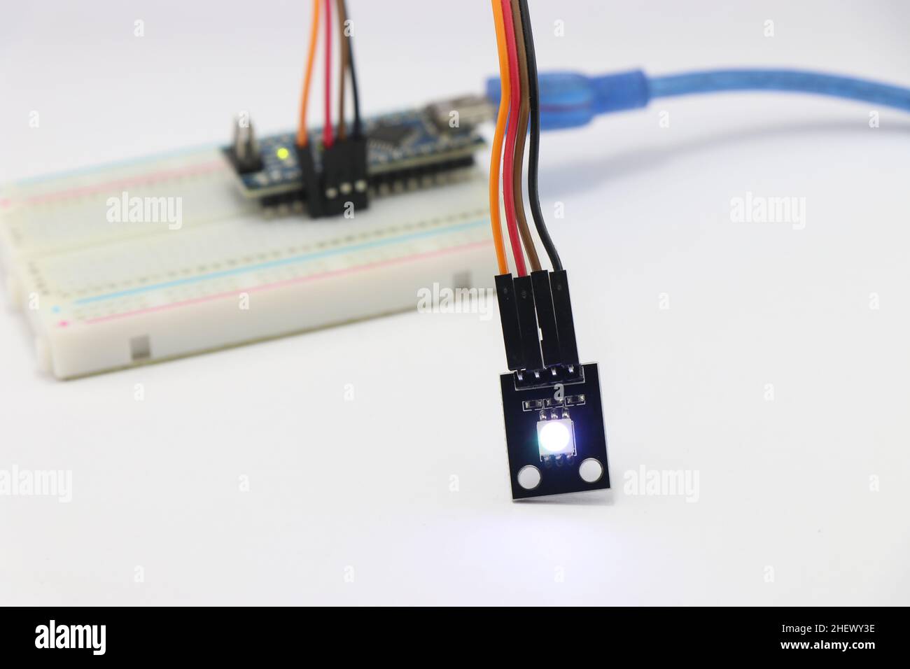 ARGB LED module connected to the breadboard using jumper wires, Various electronic parts combined to make amazing science projects Stock Photo