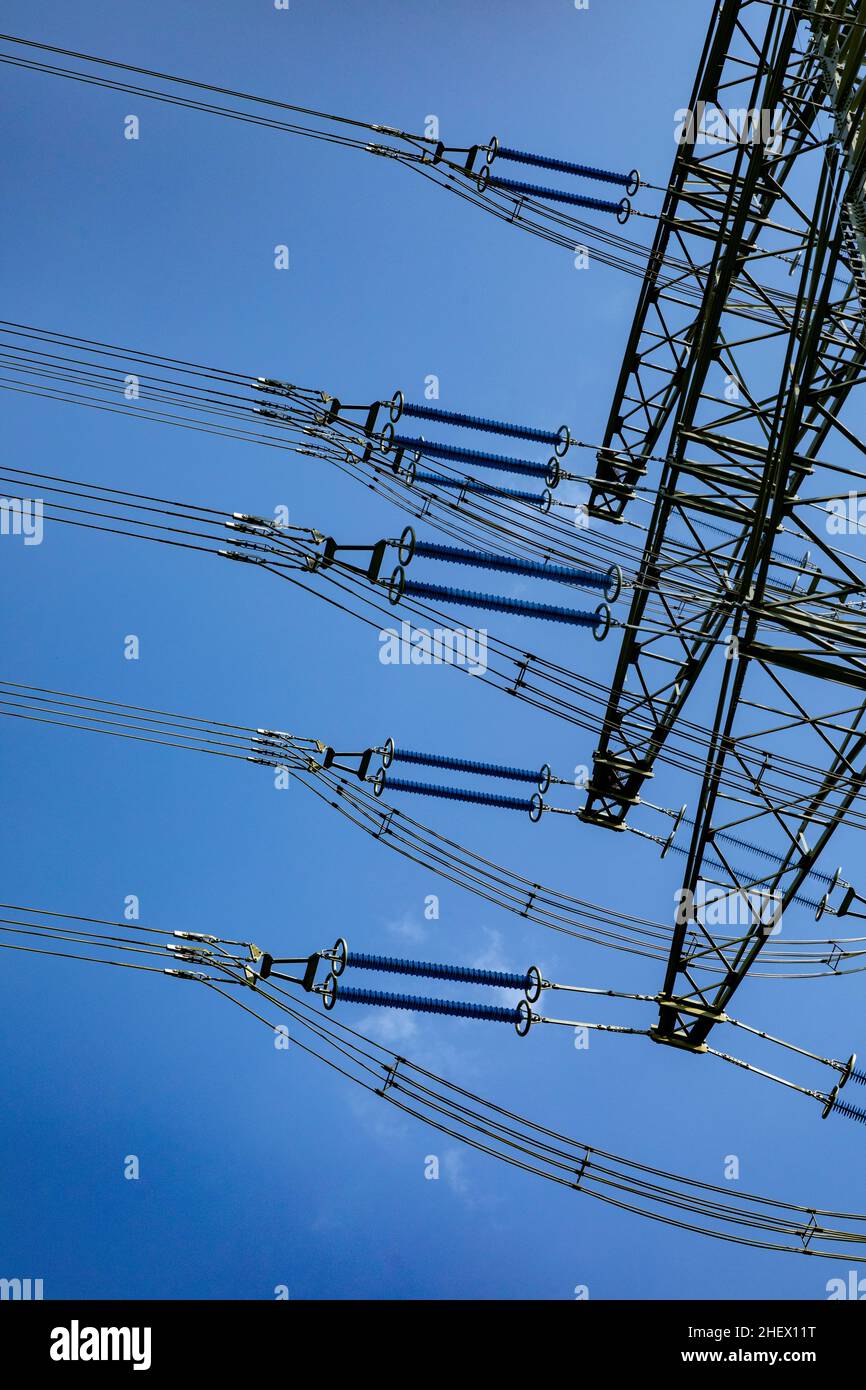 electric pylon under blue sky as industry background Stock Photo - Alamy