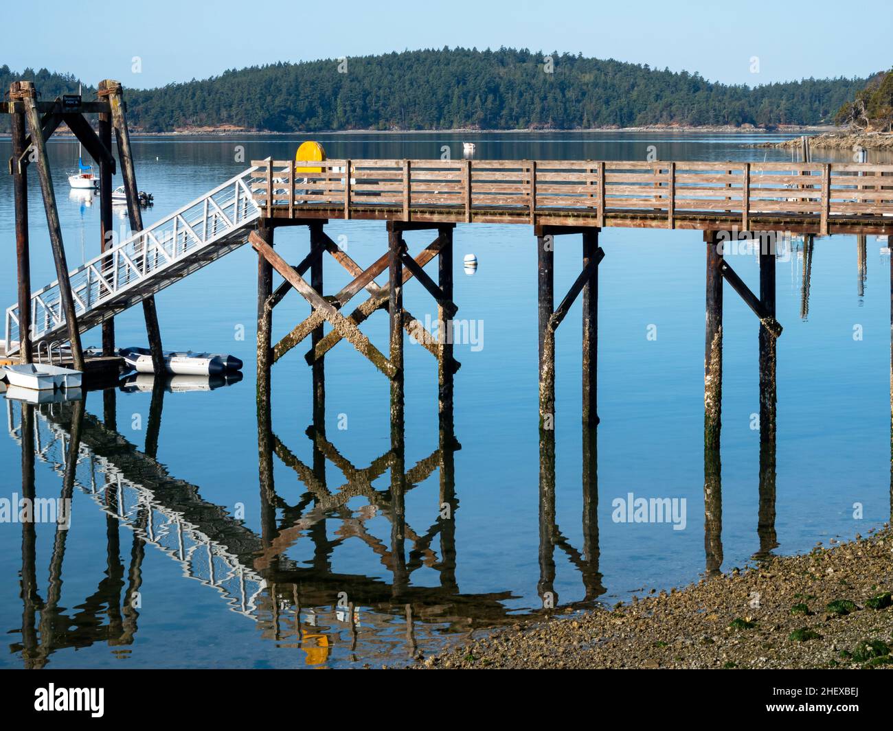 WA21084-00...WASHINGTON - Private dock and its reflection at West Sound on Orcas Island. Stock Photo