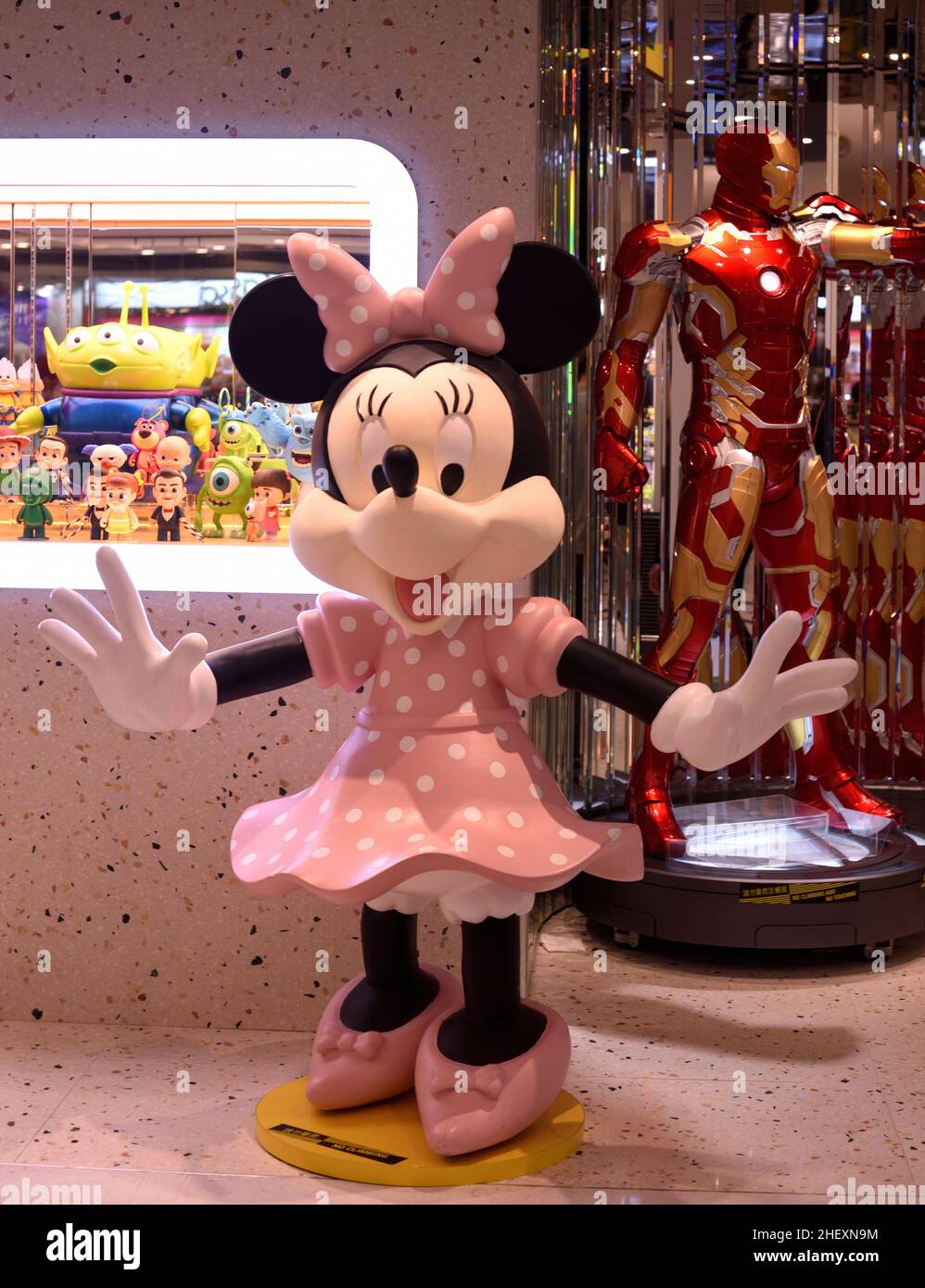 Cheerful Minnie shows welcome with open arms at a toy shop front Stock Photo