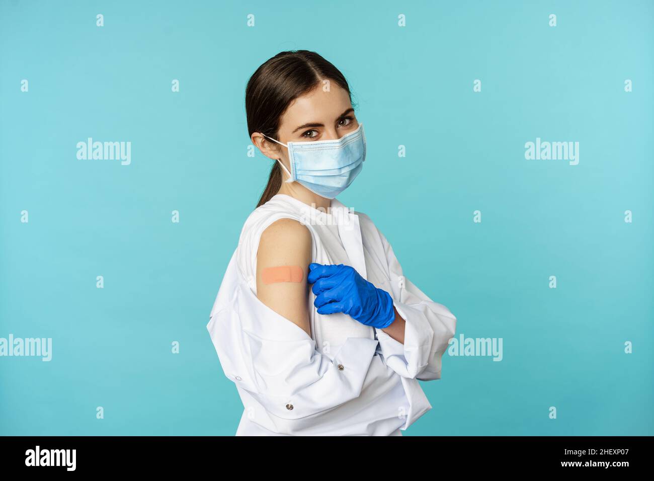 Young female doctor, nurse in medical face mask and hospital uniform ...