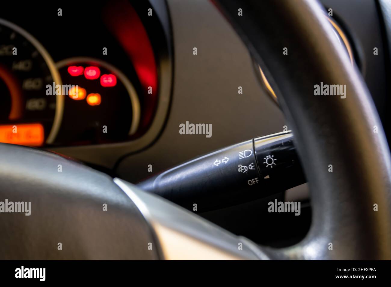 light lever and steering wheels of modern car dashboard with blurry and