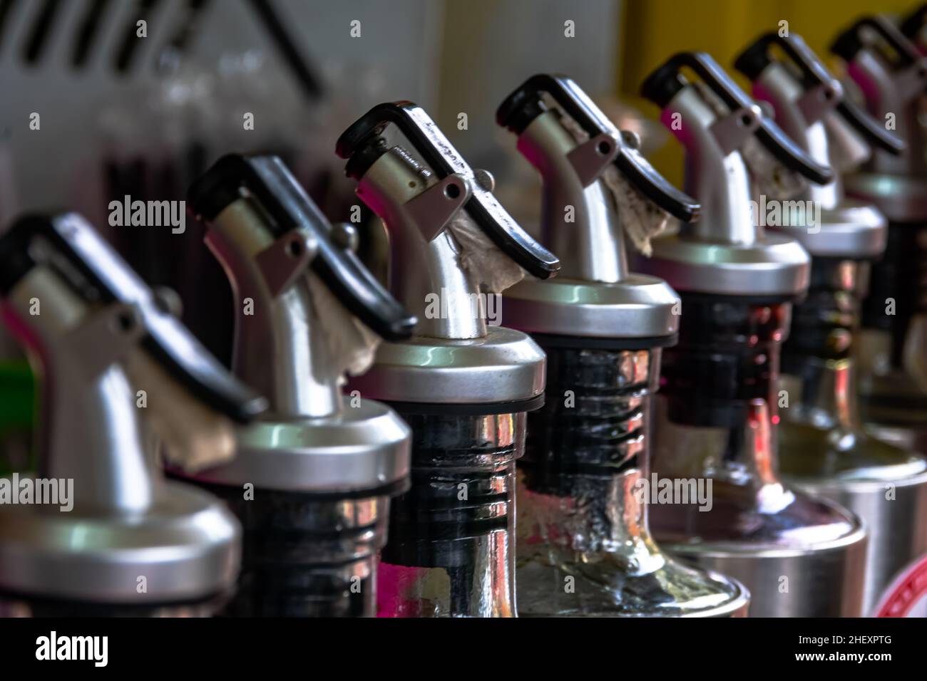 line of professional stainless steel bottles cap of syrup from the street food bar vendor Stock Photo