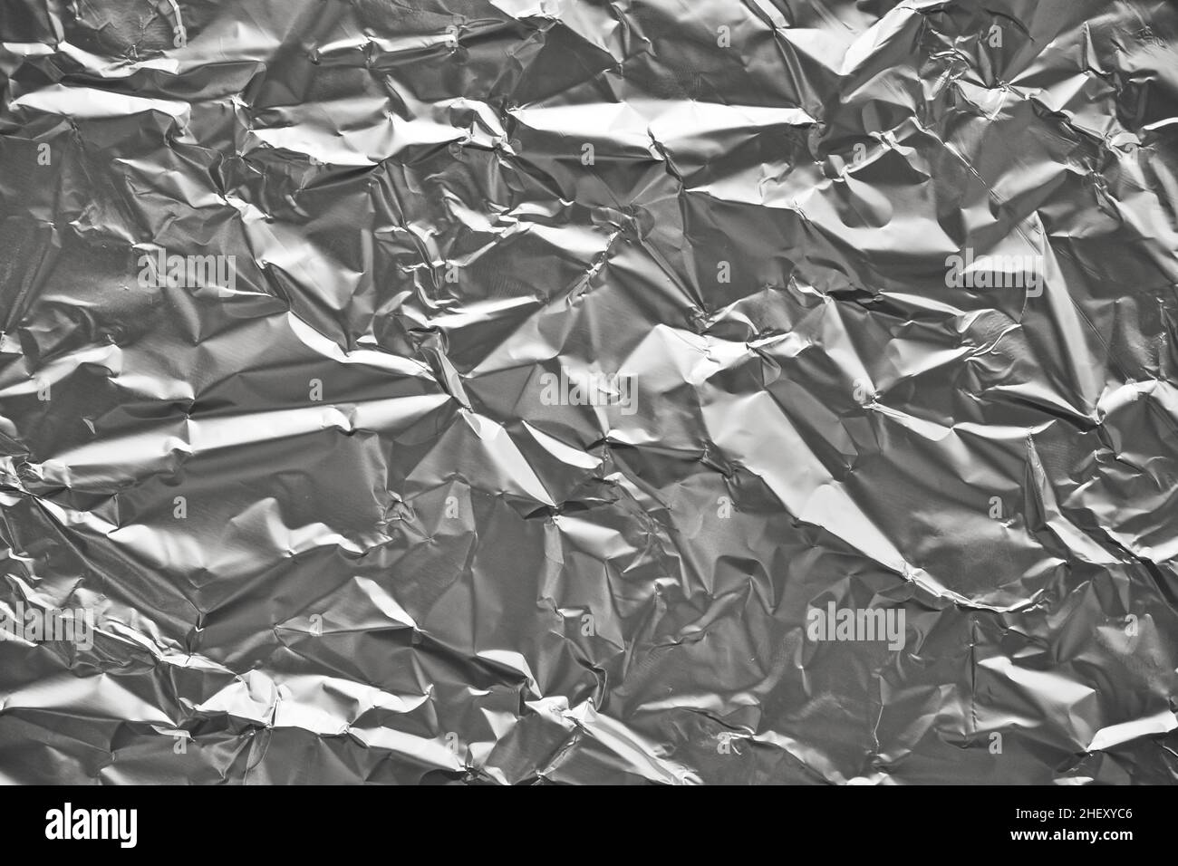 Close-up of crumpled silver aluminum foil texture. Abstract background for design. Stock Photo