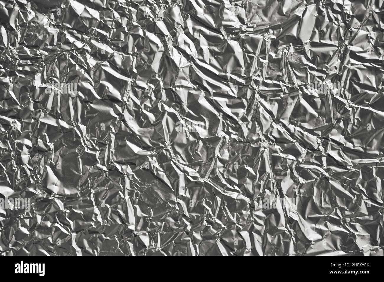 Close-up of crumpled silver aluminum foil texture. Abstract background for design. Stock Photo