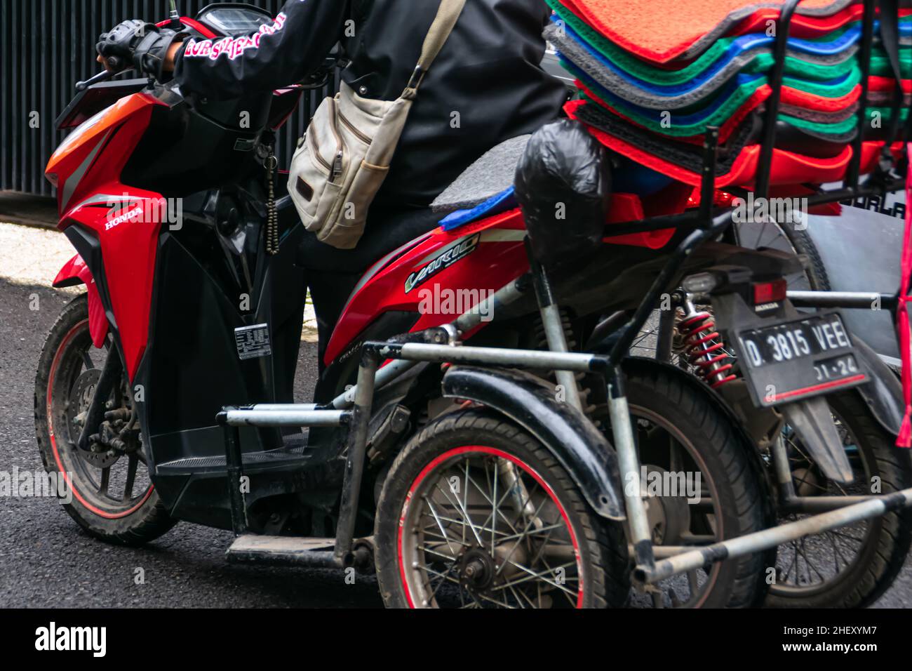 physical disability man seller modified his red motorcycle into a trike