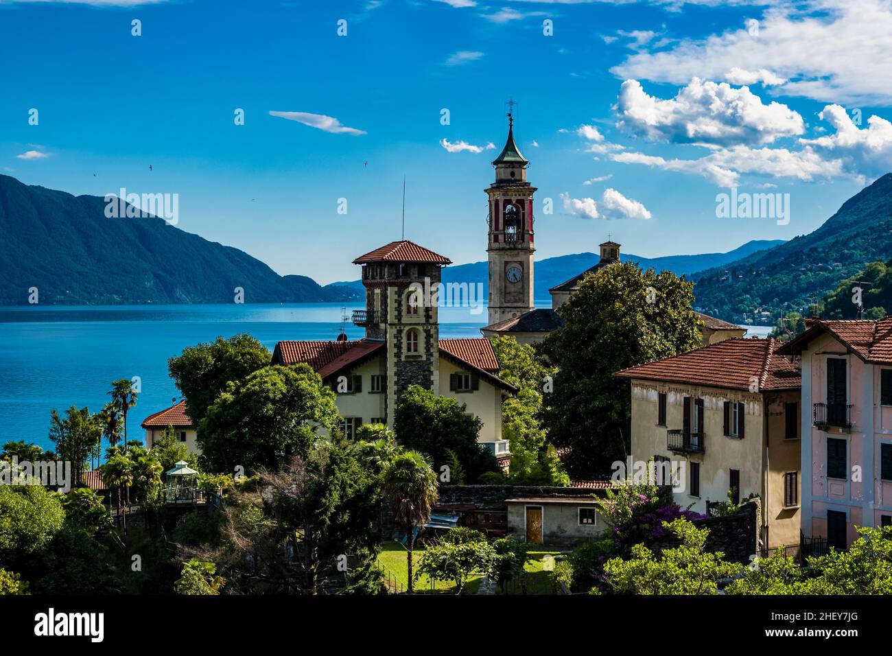 View of the church Chiesa Parrocchiale di San Giorgio, Lake Maggiore and the surrounding mountains. Stock Photo