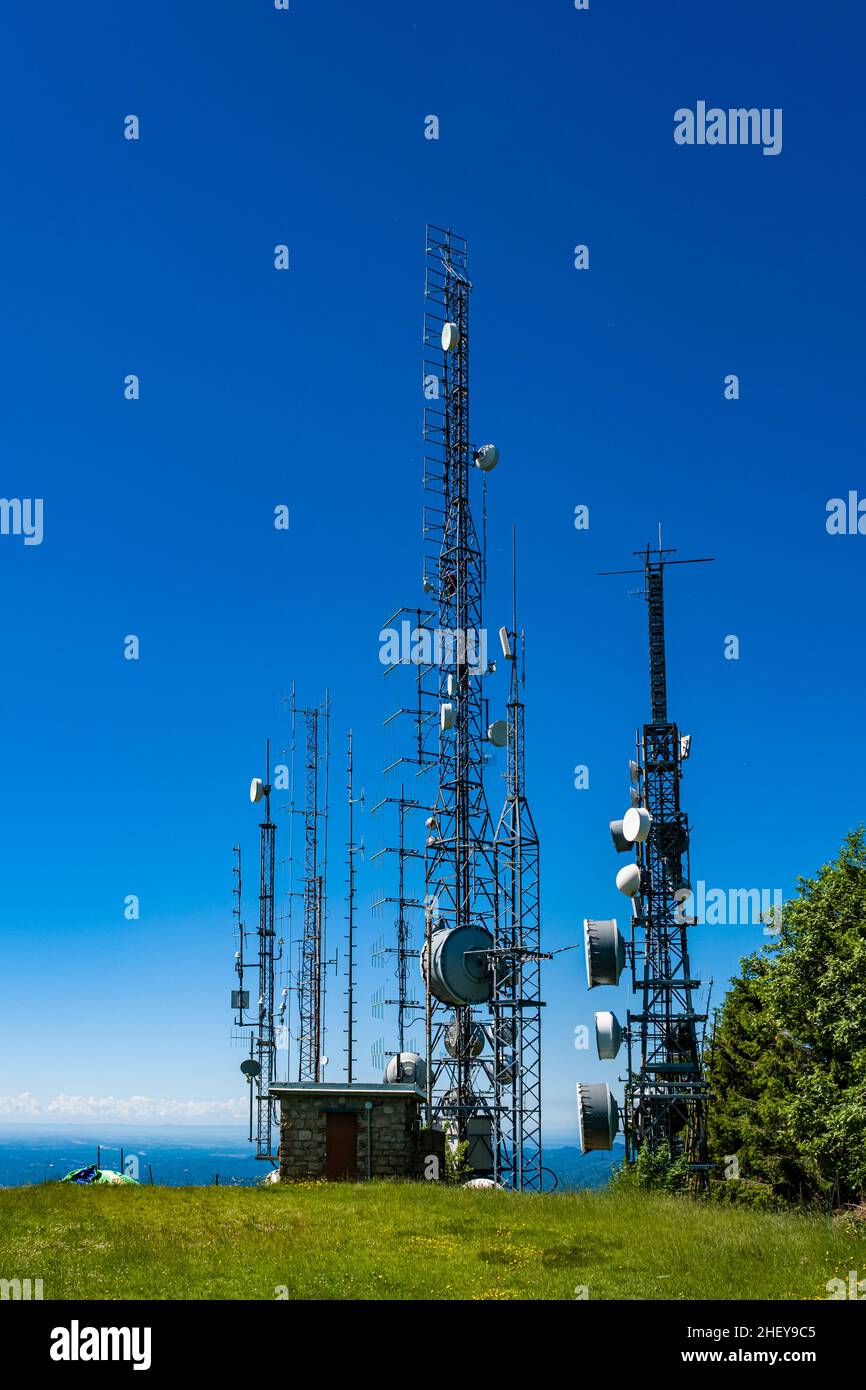 Radio masts with antennas for telecommunications and broadcasting, situated below the summit of Mottarone, high above Lake Maggiore. Stock Photo
