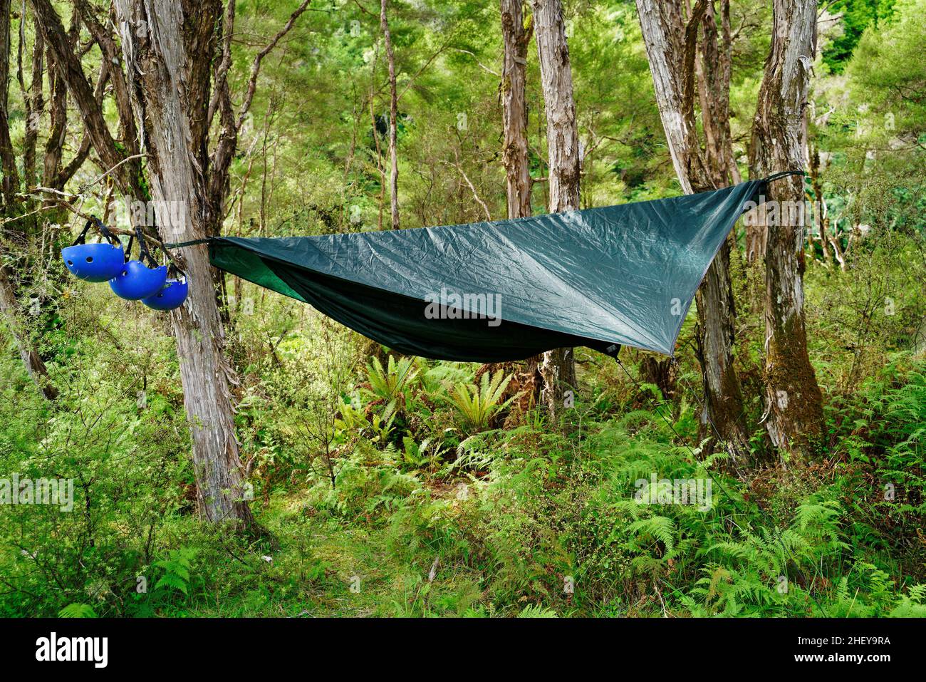 Back country camping in a hammock tent on a rafting trip, south island