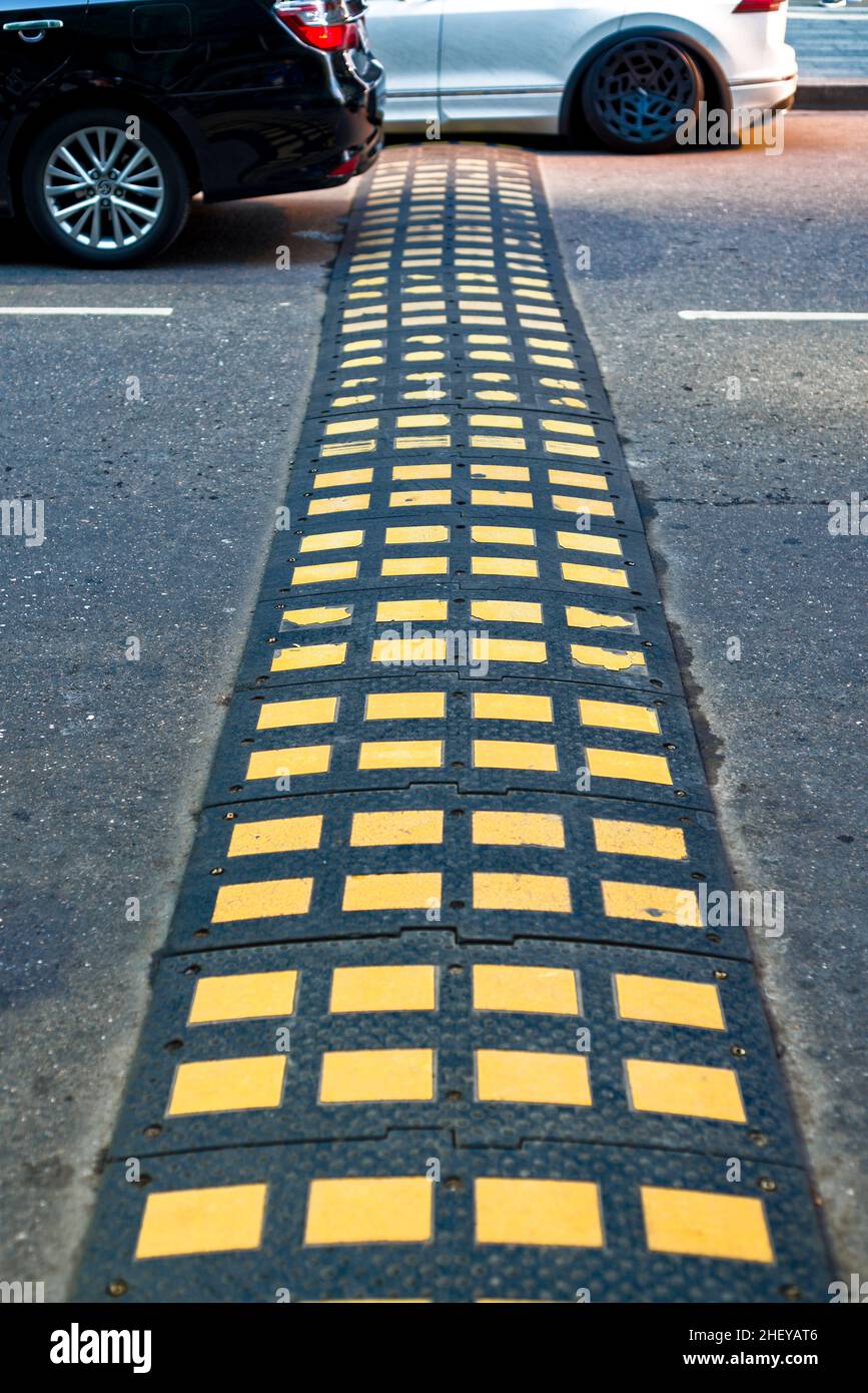 Rubber speed bump on the road Stock Photo