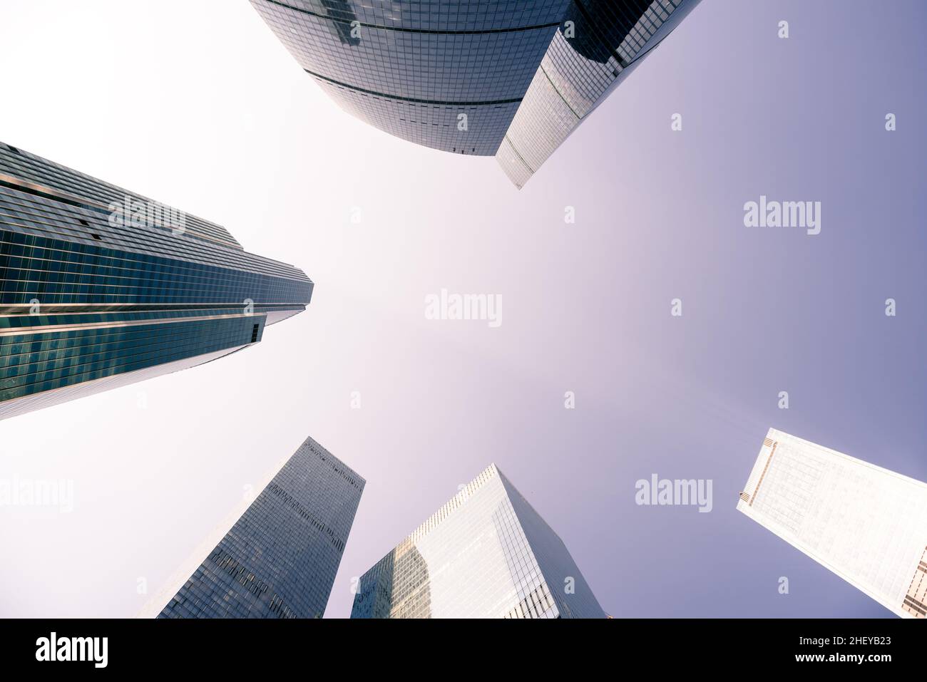 Skyscraper tops against lilac sky. Low angle view Stock Photo