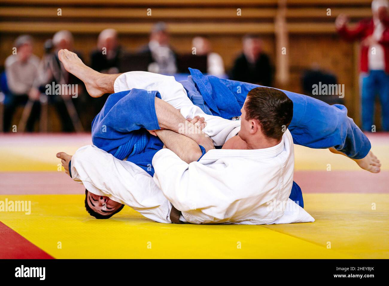 judo fighters wrestling on tatami in judo competition Stock Photo Alamy