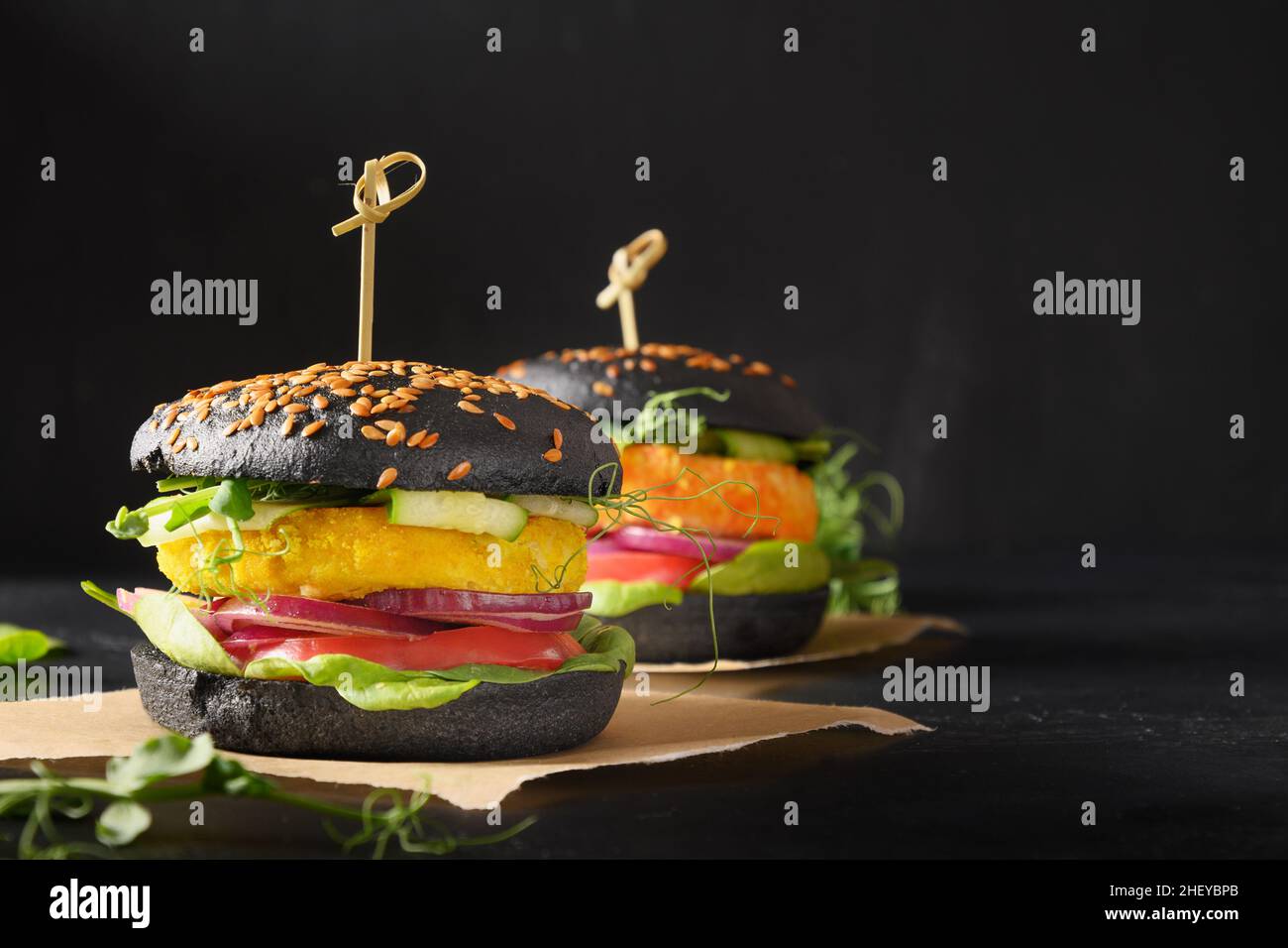 Vegan Burger of black charcoal buns, vegetables, cabbage and carrot