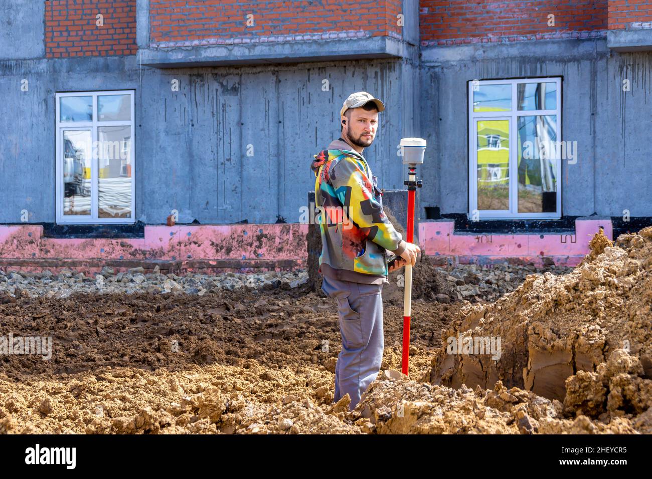 May 14, 2021, Kemerovo, Russia. A surveyor makes measurements using GPS equipment and strictly looks into the camera, selective focus Stock Photo