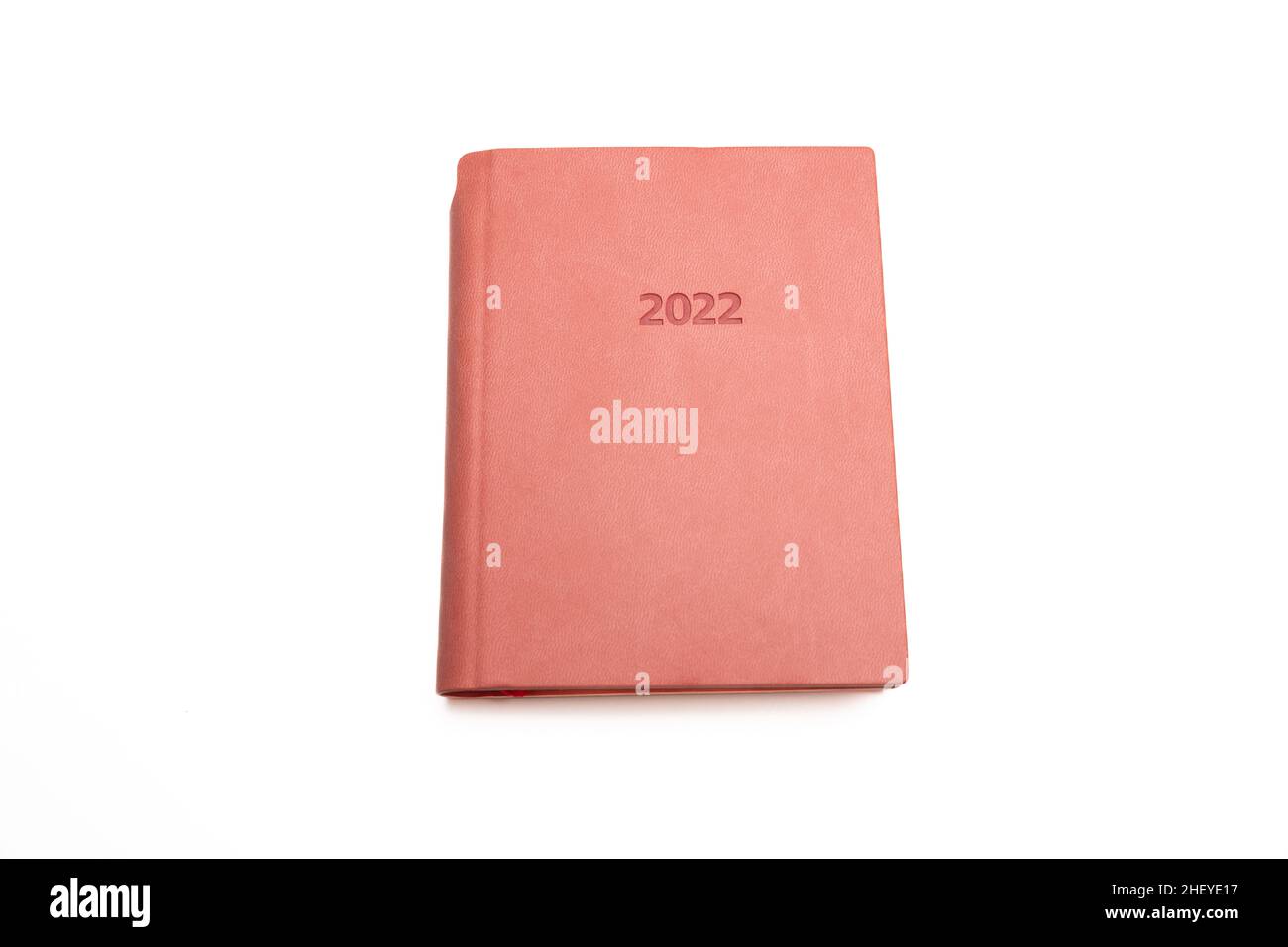 2022 year diary isolated on white background. Pink color cover, hardcover book, leather office agenda for business note Stock Photo