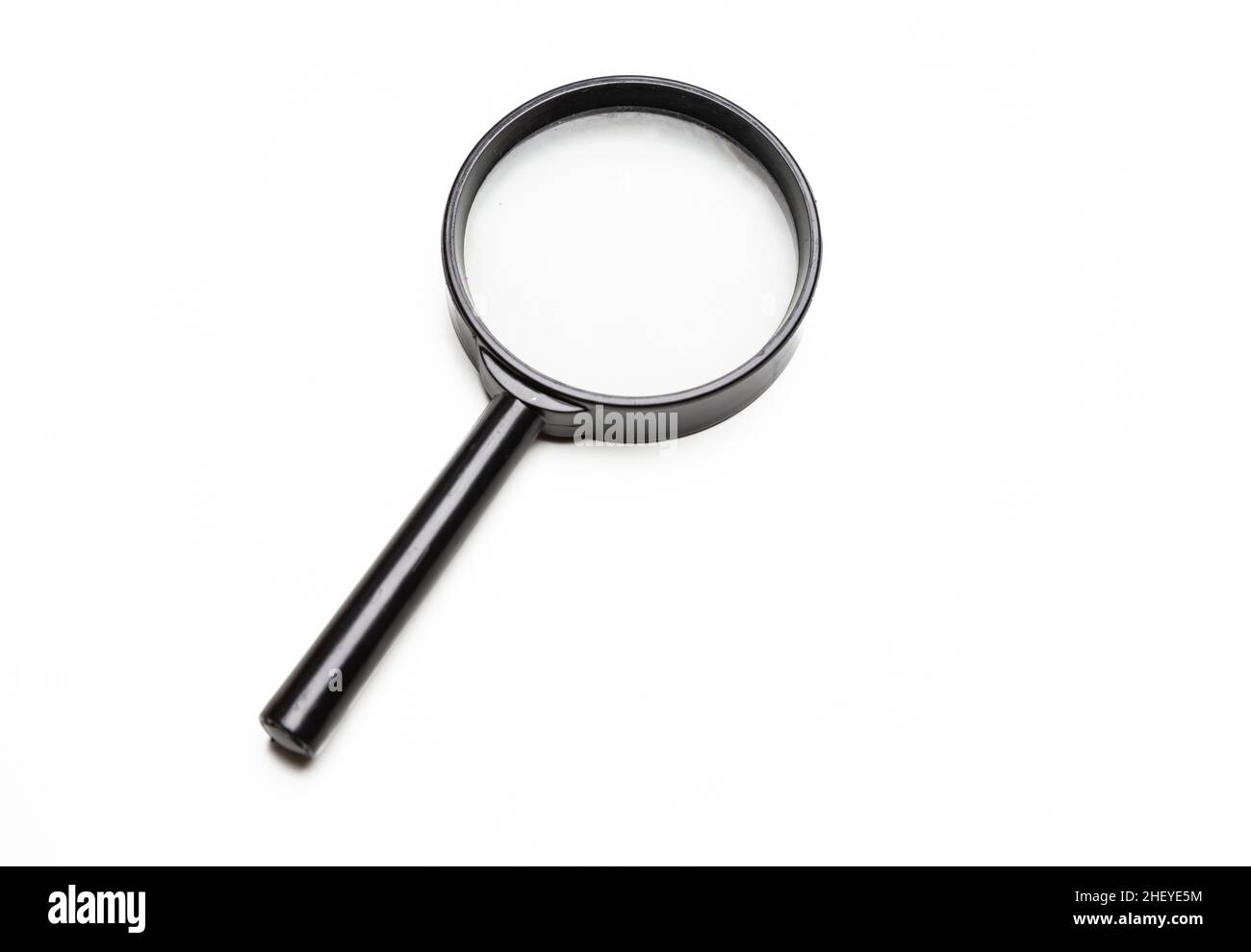 Magnifying glass. Magnify tool isolated cutout on white background. Loupe with black metal frame and handle. Search, focus concept Stock Photo